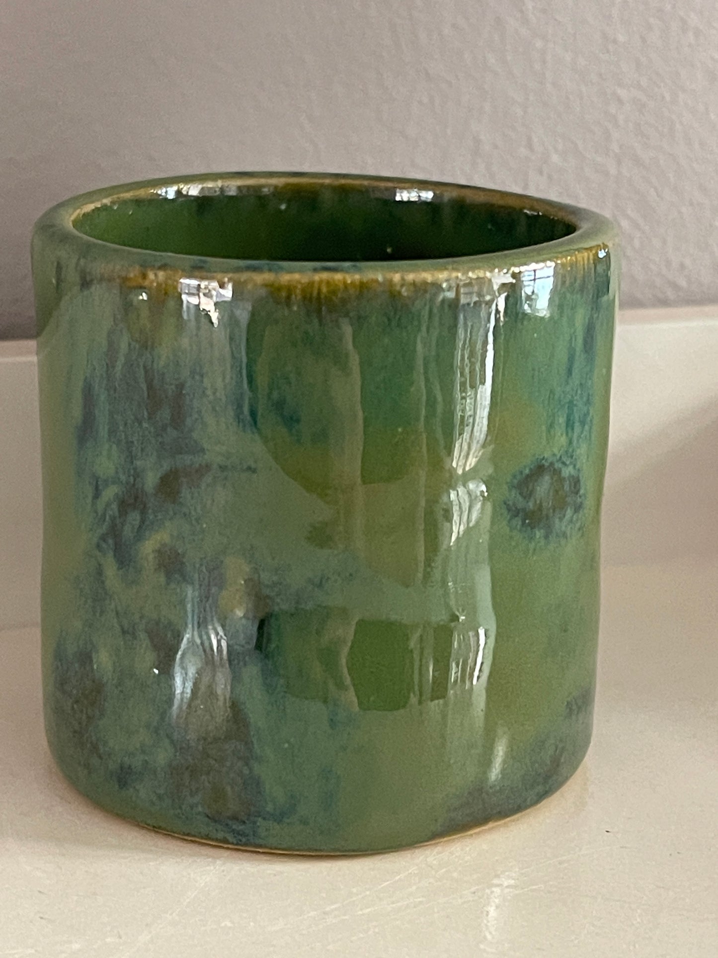 Small green hand built vase